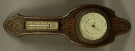 A barometer thermometer on oak back board