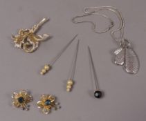 A box of red and gilt moulded leather containing a small collection of costume jewellery,