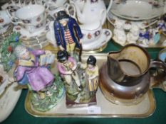 An early 19th century enamelled Staffordshire pottery figure of Saint Paul, another of a family