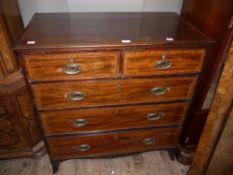 An early 19th century mahogany and rosewood banded chest of two short and three long drawers on