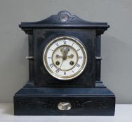 A Victorian black marble mantel clock with brocot escapement