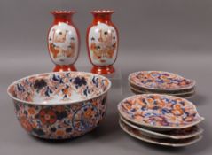 A Japanese Imari bowl painted in typical pallet with scrolling foliage, together with a set of six