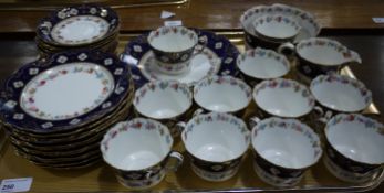 An English china tea service bordered in flowers, dark blue and gilt