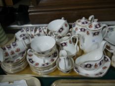 A bone china tea, coffee and part dinner service, printed in red, blue and green