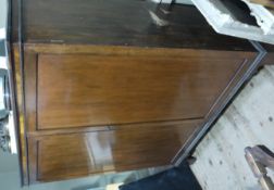 A mahogany two door cabinet fitted with narrow shelves, the back section having a lift up top