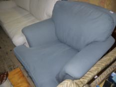 A slate blue upholstered armchair with seat and back cushion