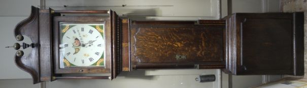 An early 19th century oak and mahogany longcase clock having a swan neck pediment with globe and