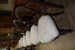 A set of six Victorian balloon back dining chairs with upholstered seats on turned legs
