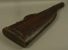 A leather gun case with brass lock