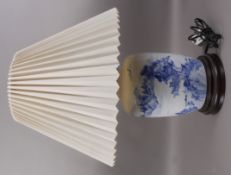 A Chinese blue and white table lamp painted with a continuous river island landscape