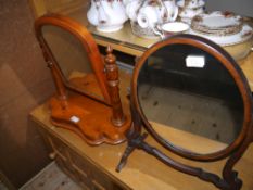 A Victorian polished beech toilet mirror of arched outline on a shaped base together with an early