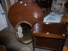 A circular tilt top tripod table together with an oak two tier curved end tea trolley and oval