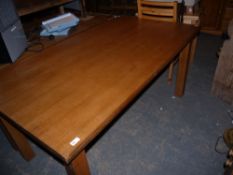 A pale oak rectangular table on square legs