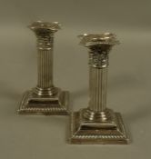 A Pair of Edward VII silver corinthian column candlesticks on square bases, Birmingham 1903, 13.