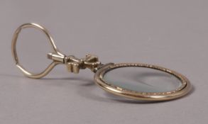 A 19th century peering glass in 15ct gold, the oval lens collet set with moline cross stem and plain