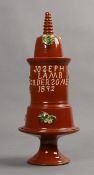 A Yorkshire red eathernware stacking four section bargeware tabacco jar, 1892, with footed base,