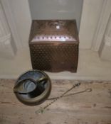 An Arts and Crafts copper coal box and cover with ring side handles and raised boss decoration to
