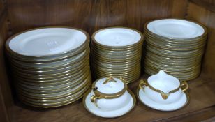 An extensive Limoges china dinner service, white bordered in gilt, comprising four meat dishes,
