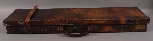 A leather gun case with brass locks and corners