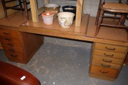 A 1950s desk with five drawers to each pedestal