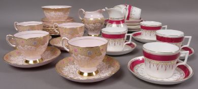A magenta and gilt tea service and a pink gilt and floral tea service
