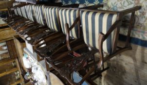 A set of twelve reproduction mahogany dining chairs of Chippendale design comprising two carvers and