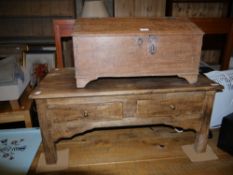 A hardwood coffee table with two drawers together with a wooden box with side carrying handles and