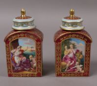 A pair of late 19th century Vienna porcelain tea caddies and covers, of flask shape painted with