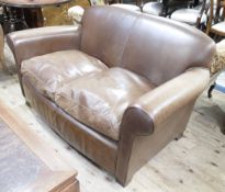 A modern brown leather two seater sofa