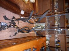 A pair of cast iron standard lamps, in the form of bull rushes together with a similar table lamp