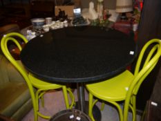 A granite and stainless steel pedestal breakfast table, with two lime green bent wood chairs