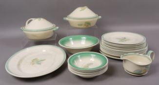 A Susie Cooper dinner service of acorn and oak leaf pattern in shades of green and yellow on a cream
