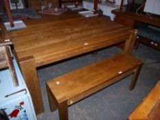 A plank top dining table and matching bench
