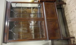 A 1920s mahogany and glazed two door display cabinet with two door cupboard below on square legs