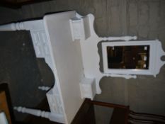 A white painted dressing table with rectangular mirror