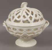 A Wedgwood cream ware two handled orange basket of spherical pierced design on a circular foot,