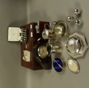 An Art Deco mantel clock, silver plated butter dish, individual coffee pot, spirit flask, three