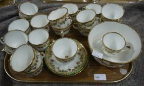 A 19th century English china part tea service bordered in pale apricot and green, comprising cups,