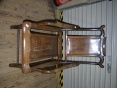 A Chinese polished elm open arm chair with panelled back and seat