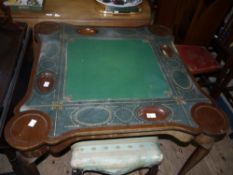 An early 20th century mahogany card table of square outline with rounded corners, counter wells