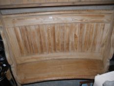 A pine settle with curved back and shaped side panels