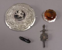 A Scottish silver brooch claw set to the centre with a circular faceted paste by Ward Brother,