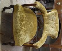 An Edwardian mahogany framed salon tub chair on cabriole legs with castors