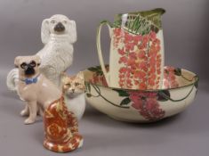 A Royal Doulton toilet jug and bowl decorated with wisteria together with a pottery spaniel, pottery