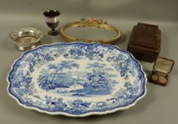A Barbola mirror of oval outline, a plated on copper wine coaster, large blue and white printed meat