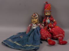 Two Indian puppets, having carved and painted faces and cloth bodies