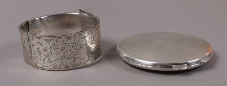 A silver compact c.1920 of circular outline with engine turning and monogrammed FVC, Birmingham 1920