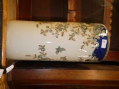 A reproduction umbrella tile, circular outline printed in a blue and brown flowering branches