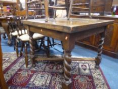 AN OAK BARLEY TWIST DRAW LEAF TABLE, with cross stretcher base and four spindle back chairs (5)