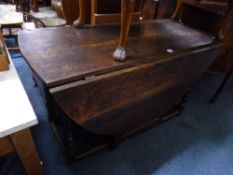 AN EARLY OAK OVAL GATE LEG TABLE, with bobbin turned supports, approximate size extended length